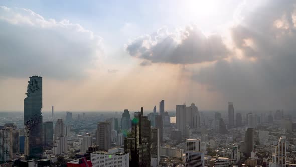 Sunburst or sun rays or god light beam through the cloud over Bangkok city center – Time Lapse