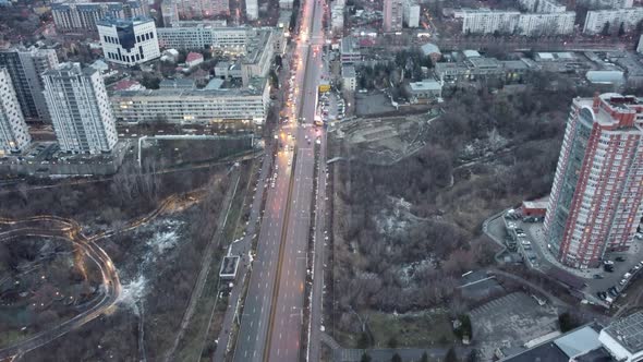 Aerial gray winter city with evening street lights