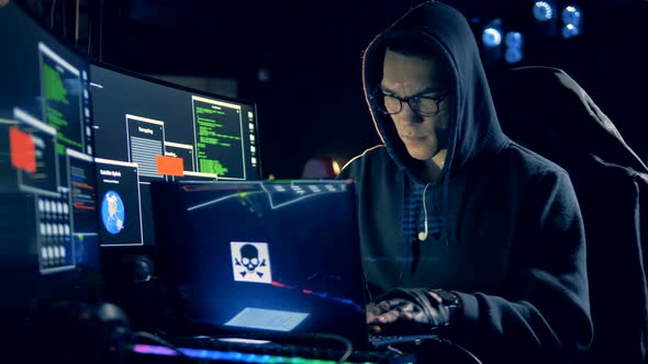 A Hacker Works with a Laptop, Cracking System. Cyber Technology Network Safety and Protection alt