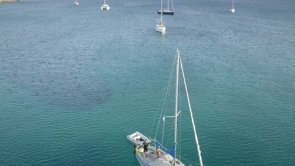Aerial view of sailboats sailing cross blue and clean sea in Greece. alt