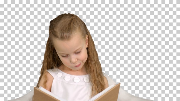Pretty little girl sitting with book and reading, Alpha Channel