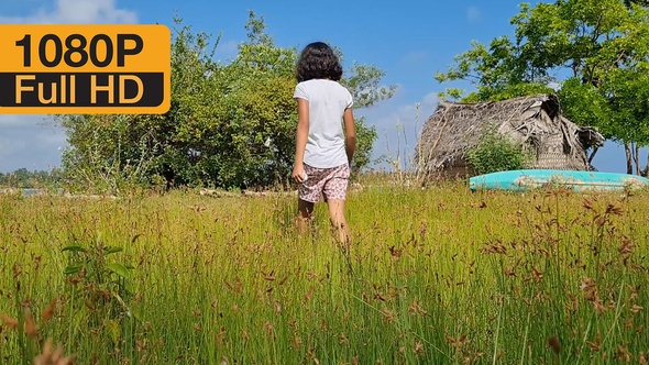 Child Walking On Grass Field alt
