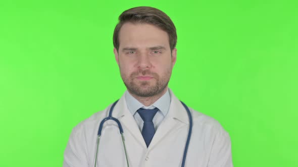 Thumbs Down by Young Doctor on Green Background alt