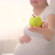 Pregnant Woman is Holding an Apple in Her Hand - VideoHive Item for Sale