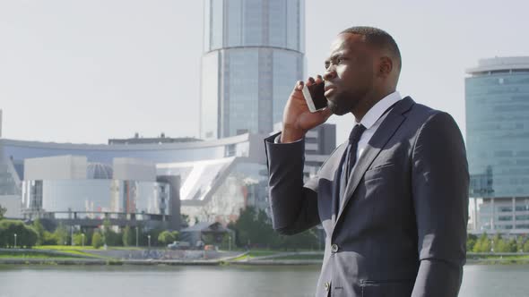 Afro Business Man Talking On Phone Outdoors alt