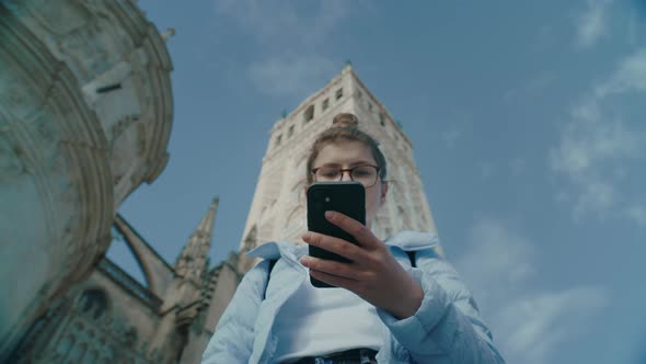 Woman Use Smartphone on City Street to Text