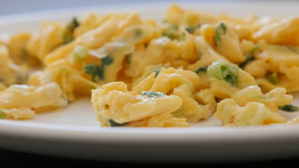 Fried eggs with scallion green onion on the plate 4K 2160p 30fps UltraHD footage - Tasty breakfast e alt