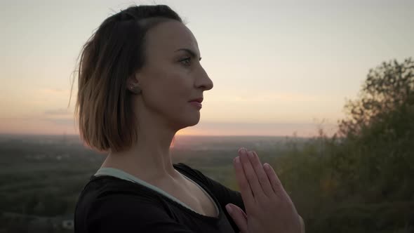 Portrait Woman Stand on Yoga Mat and Practicing Yoga Stretching Exercise Outdoors in Sunset alt