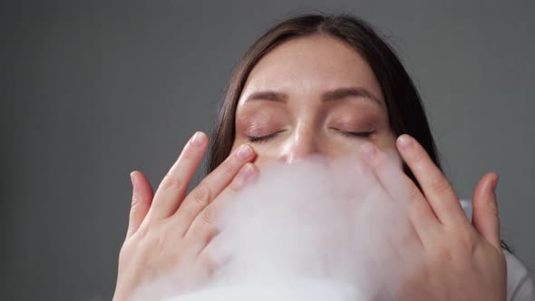 Woman Doing Steam Therapy with Humidifier Sitting in Room alt