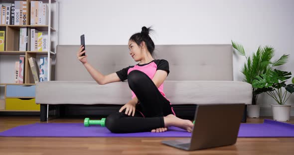 Woman trainer taking selfie with smartphone alt