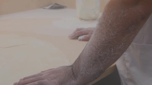 Baker's Hairy Hands Covered with White Flour When Working with Dough Starch and Flour