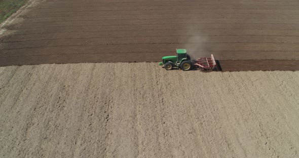 Tractor on the Field Working Aerial View alt