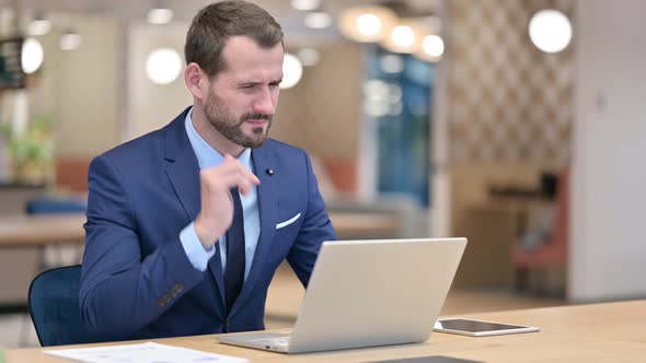 Tired Businessman with Laptop Having Neck Pain in Office  alt