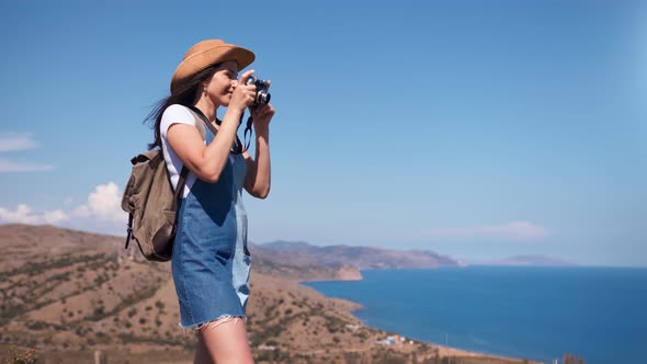 Active Tourist Happy Woman Taking Picture of Amazing Nature Seascape Using Camera alt