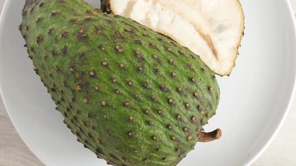 Closeup of Green Soursop Graviola, Exotic, Tropical Fruit Guanabana on Plate alt