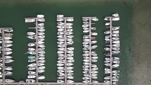 Boats Lined Up At Docking Terminal In Howth Harbour, Dublin, Ireland. aerial drone, top-down alt