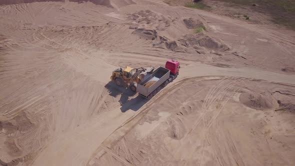 Excavator is loading empty truck alt