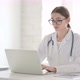 Female Doctor Working on Laptop in Office - VideoHive Item for Sale