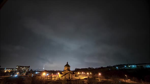 Beautiful time lapse: massive clouds floating night city sky.