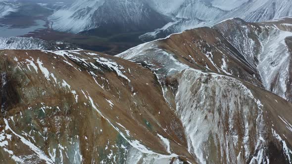 Drone Over Snowy Mountain Peaks alt