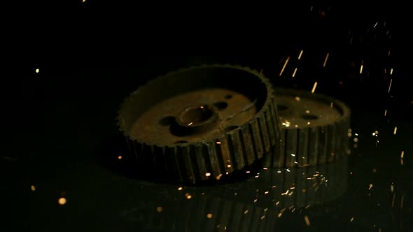Sparks with gears in ultra slow motion 1500fps on a reflective surface - SPARKS w GEARS  alt
