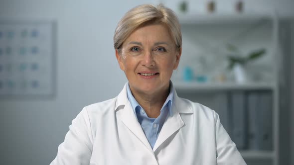 Professional Female Doctor in Uniform Smiling on Camera, Medical Occupation