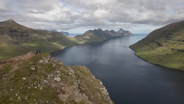 Drone Over Hikers On Klakkur With Mountains And Sea Beyond alt