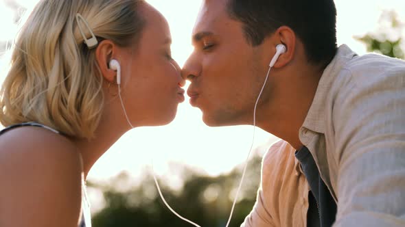 Happy Couple with Earphones Kissing