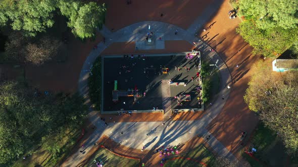 Drone. Playground square, children family animals, city springtime,  bird's eye closer view . alt