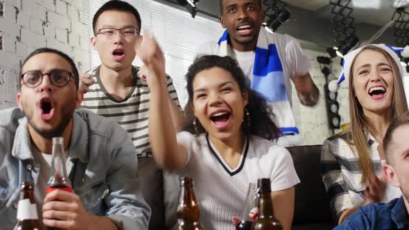 Diverse friends watching TV sport match