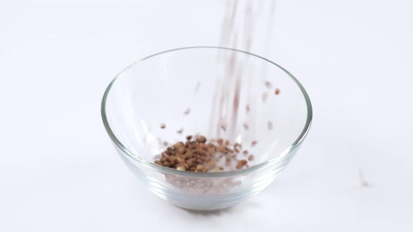 Green lentils in a glass bowl on white background. Healthy organic food diet concept.