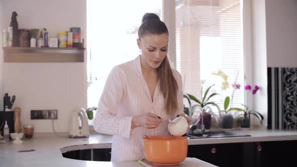 Front View of Pretty Woman Cooking at Spacious Kitchen