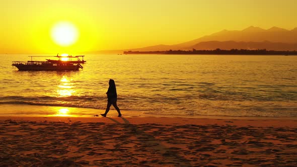 Pretty smiling lady relaxing having fun on the beach on sunny blue and white sand background 4K alt