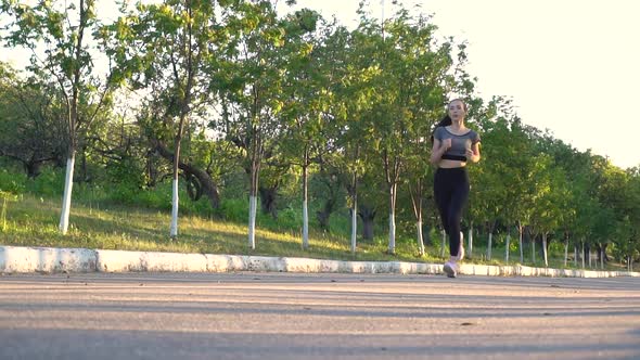 Young Sporty Woman Are Exercising with Outdoor Running in the City Park