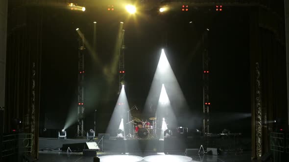 Stage Lighting. Light Show. Musical Instruments and Drum Set on an Empty Stage alt