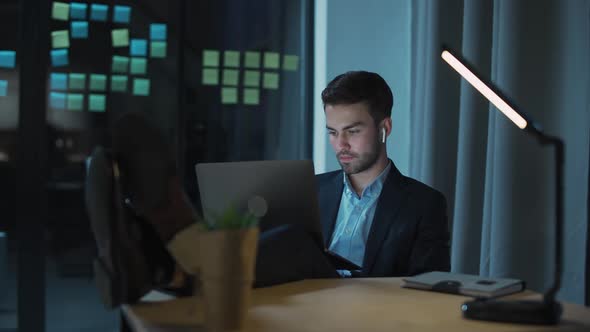 Workaholic at Work Office Manager Works Late a Tired Man with a Laptop on His Lap Works Overtime alt
