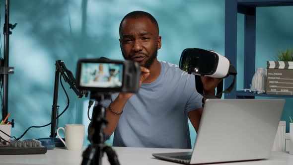 Vlogger Holding Vr Glasses for Product Review with Camera alt