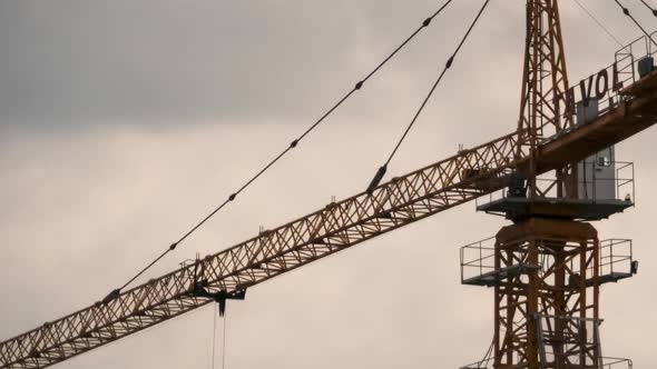 Tower Crane on a Construction Site on a Clouds Backdrop. Timelapse. alt
