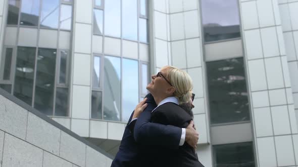 Successful Man and Woman Hugging Happy About Successful Business Deal, Cooperate