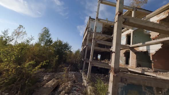 FPV Drone Flies Quickly and Maneuverable Among Abandoned Industrial Buildings and Around an alt
