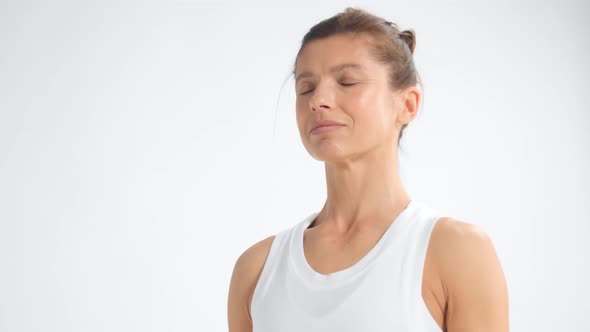 Senior Woman in White Space Practice Yoga