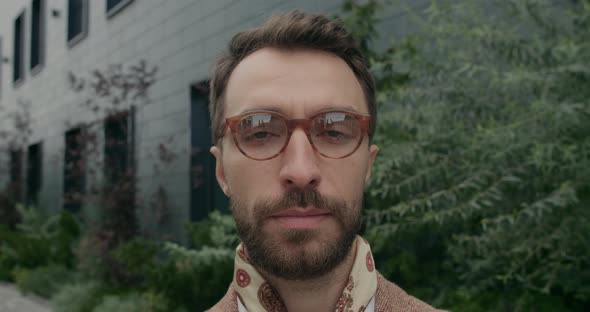 Portrait of Serious Bearded Man with Neckerchief Looking Aside and Than To Camera alt