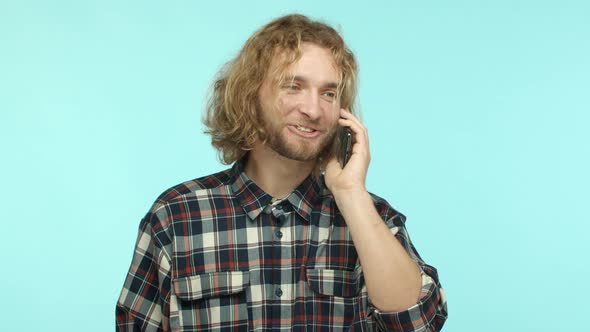 Slow Motion of Handsome Blond Man with Beard and Wavy Long Hair Calling Friend Having Conversation