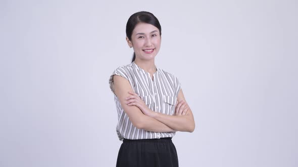 Happy Beautiful Asian Businesswoman Smiling with Arms Crossed alt