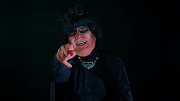Creepy Man Grandfather with Halloween Stylish Witcher Makeup Pointing Finger to Camera Laughing alt