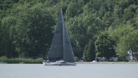 A sailboat moving closer the main harbor on the Balaton lake, Tihany. alt