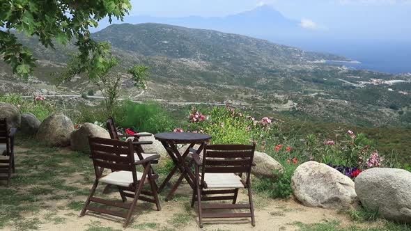 Chairs and table with view on mountains in Greece