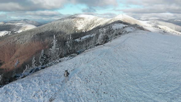 Drone Flying Over Man Hiker Walking on a Summit Ridge alt