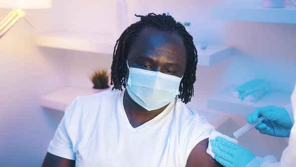 Portrait of African American Black Man Getting Vaccine Against Coronavirus alt