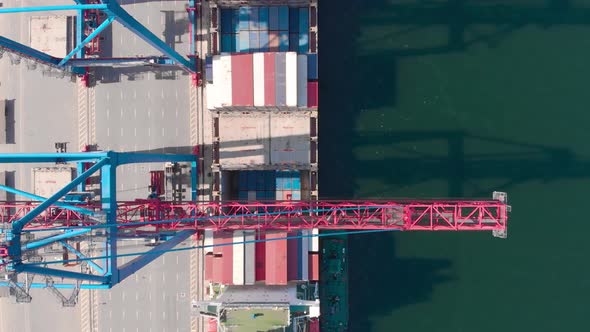 Drone Flying Over a Container Ship During Cargo Operations Over the Customs Area alt
